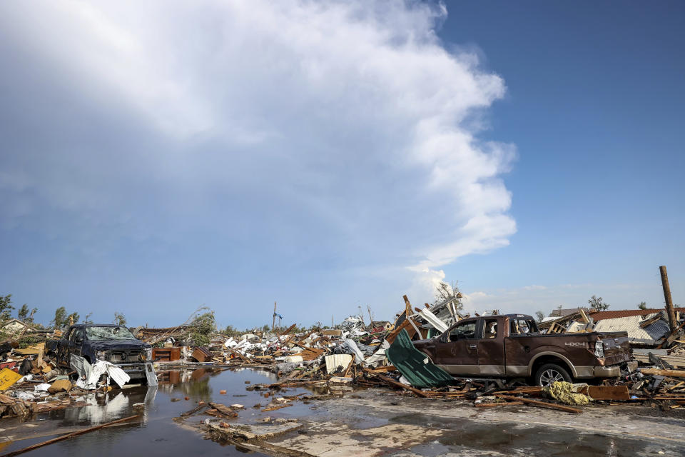 Damaged pickup trucks sit among debris after a tornado passed through a residential area in Perryton, Texas, Thursday, June 15, 2023. (AP Photo/David Erickson)