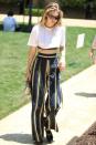<p>In a white crop top, Tanya Taylor high-wasted striped pants, Andre Assous slippers, cat-eye sunglasses and holding a STALVEY purse while out in LA. </p>