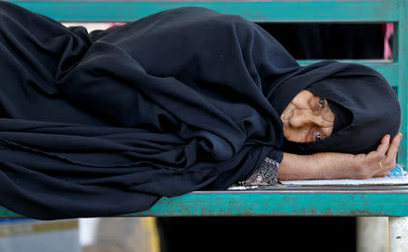 A woman with cancer lies on a bench as she waits at The National Oncology Centre in Sanaa, Yemen, July 23, 2018. REUTERS/Khaled Abdullah