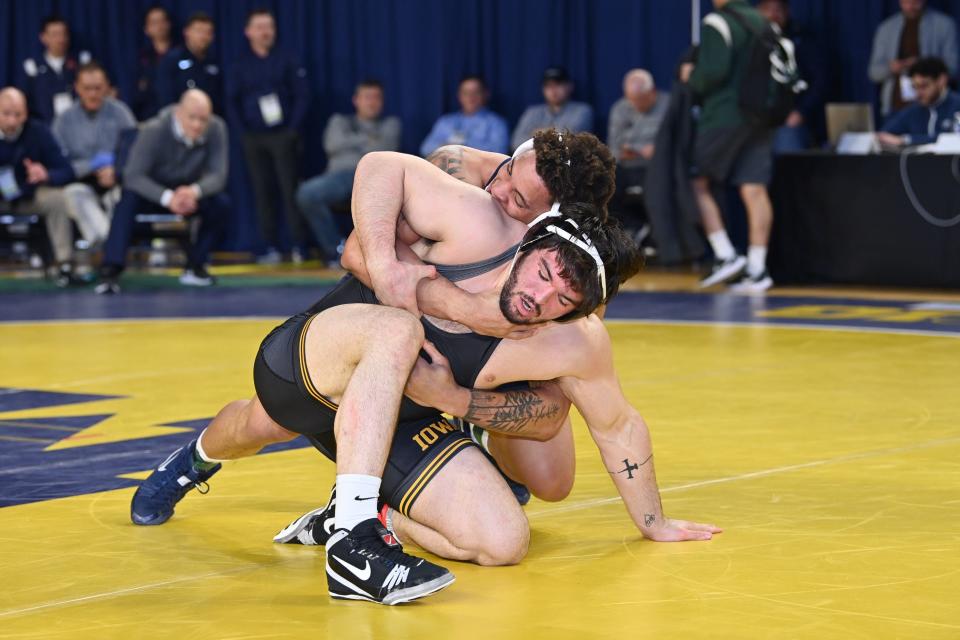 Iowa wrestler Tony Cassioppi tries to escape from Penn State's Greg Kerkvliet at the 2023 Big Ten Wrestling Championships in Ann Arbor, Mich. Kerkvliet beat Cassioppi, 5-0, to advance to the heavyweight finals.