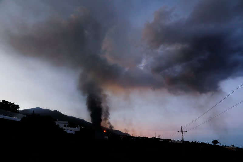 Lava and smoke rise following the eruption of a volcano on the Canary Island of La Palma