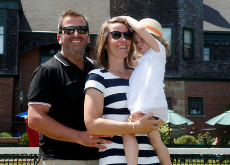 Justine Henin of Belgium holds her daughter Lalie, 3, as she poses for a photo with her husband Benoit Bertuzzo after being inducted into the International Tennis Hall of Fame in Newport, Rhode Island, U.S. July 16, 2016. REUTERS/Mary Schwalm