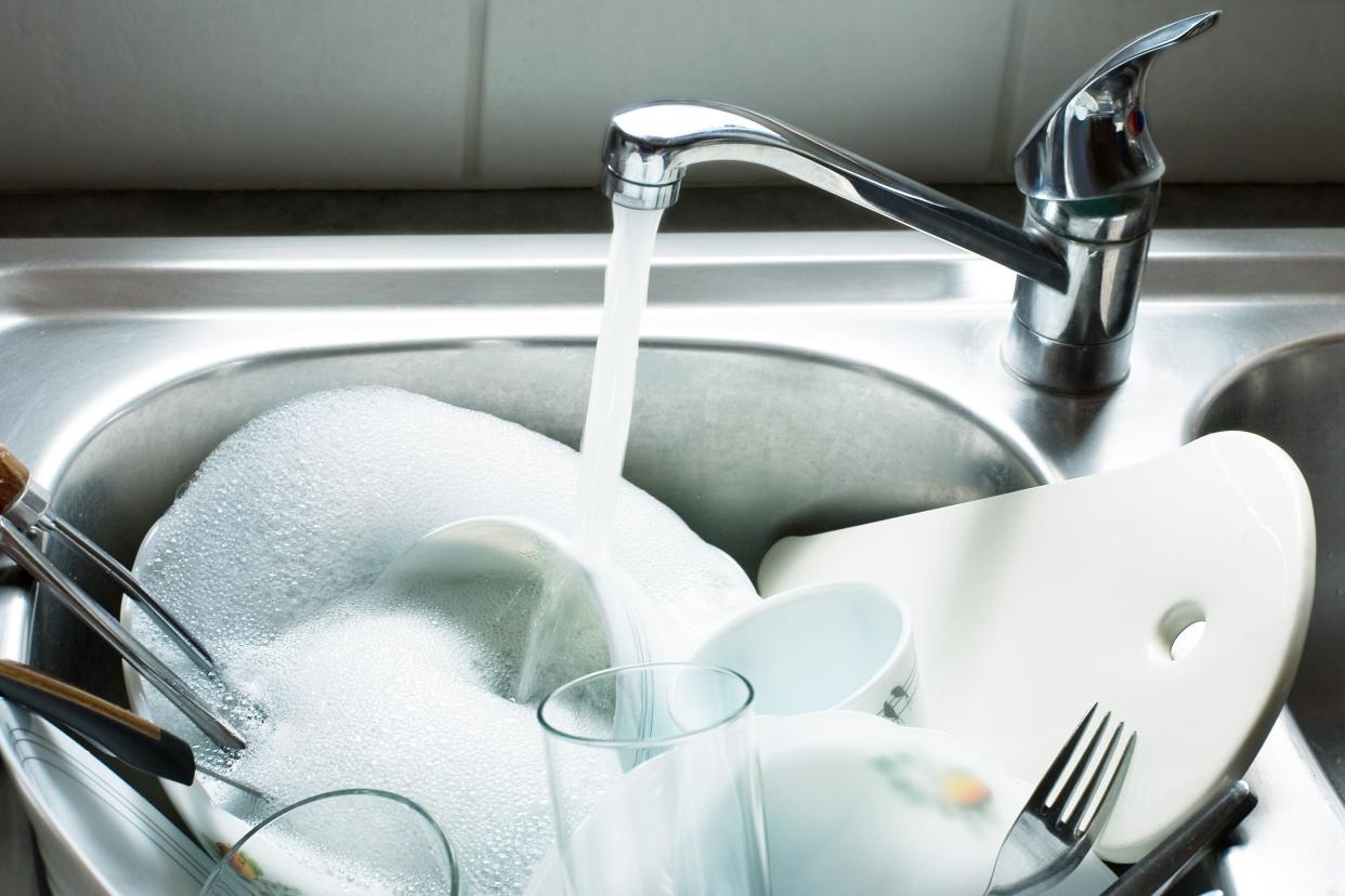 washing kitchen ware on the sink