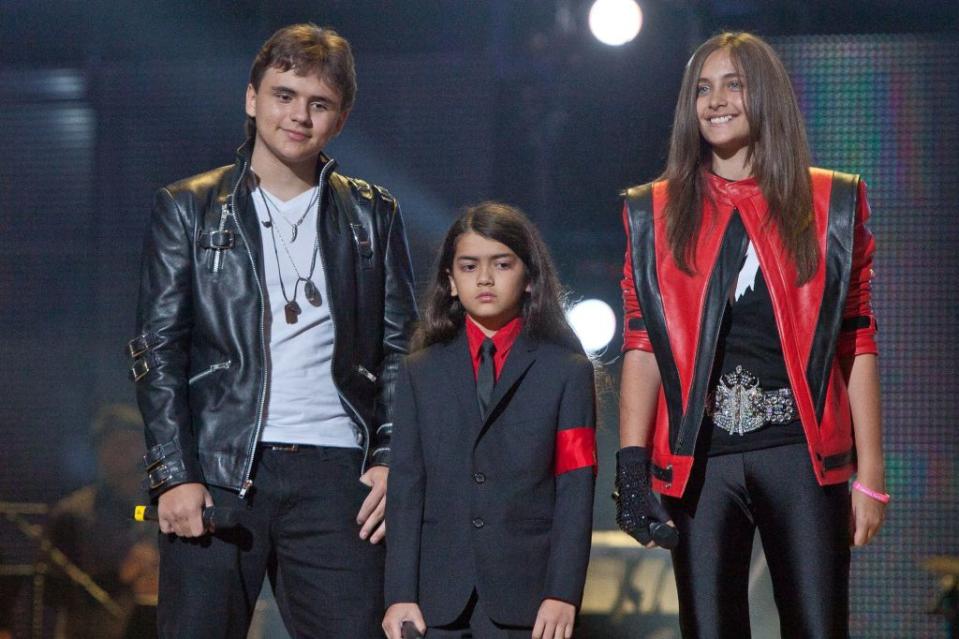 In this Oct. 8, 2011, photo, from left, Prince Jackson, Prince Michael II “Blanket” Jackson and Paris Jackson arrive on stage at the Michael Forever the Tribute Concert, at the Millennium Stadium in Cardiff, Wales.