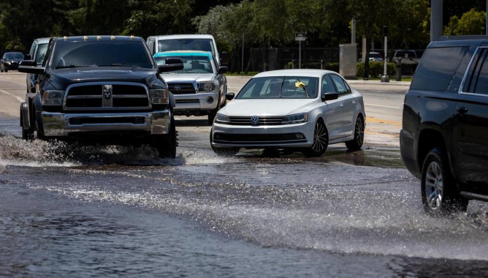 Motorists navigate around a stranded vehicle at the corner of Southwest 4th Avenue and 27th Street in Fort Lauderdale on April 14, 2023.