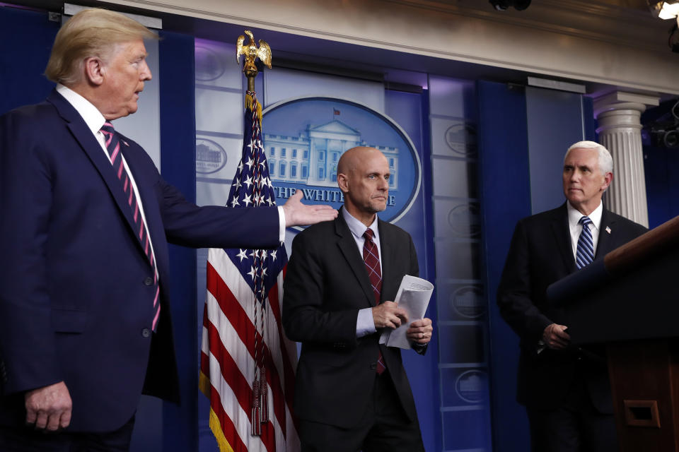 FILE - In this April 24, 2020, file photo, President Donald Trump gestures to Vice President Mike Pence as Dr. Stephen Hahn, commissioner of the U.S. Food and Drug Administration, steps back to the podium to answer a question during a briefing about the coronavirus in the James Brady Press Briefing Room of the White House in Washington. White House chief of staff Mark Meadows has pressed Hahn to grant an emergency use authorization for Pfizer’s coronavirus vaccine by the end of the day on Dec. 11. (AP Photo/Alex Brandon, File)