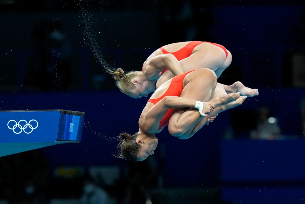 Jessica Parratto, in front, and Delaney Schnell of the United States' compete during the women's synchronized 10m platform diving final at the Tokyo Aquatics Centre at the 2020 Summer Olympics, Tuesday, July 27, 2021, in Tokyo, Japan.