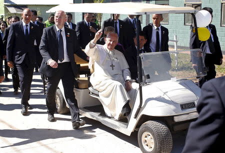 Pope Francis waves as he leaves the Bolivian prison of Palmasola in Santa Cruz, Bolivia July 10, 2015. REUTERS/Alessandro Bianchi