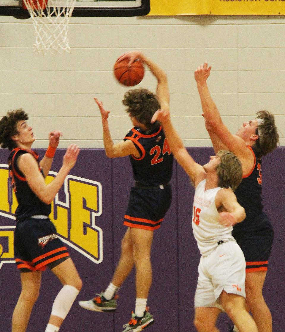 Kerr Bauman grabs a rebound in front of teammates Riley Weber, left, and Logan Barnett, as well as James Moore of New Berlin, in Saturday's IPC-Sangamo Shootout game at Williamsville.
