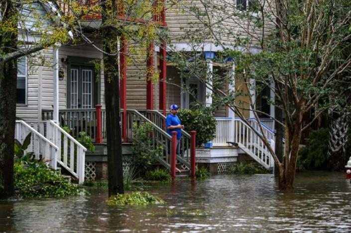 A man stands outside his home on a street flooded by Hurricane Sally in Pensacola, Florida, on September 16, 2020