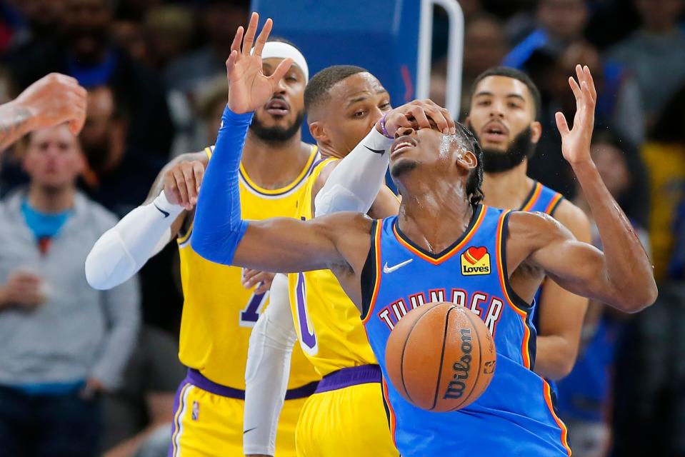Thunder guard Shai Gilgeous-Alexander (2) is fouled by Lakers guard Russell Westbrook (0) on Oct. 27.