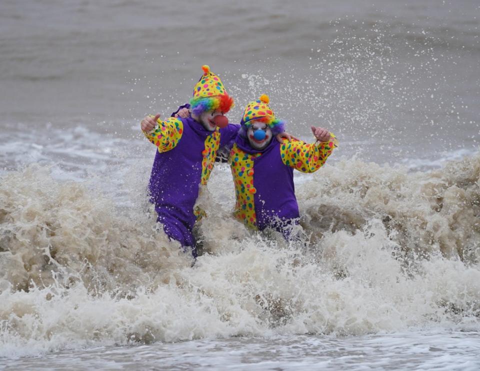 Swimmers Perry Springate and Chris Johnson dressed as clowns for their Christmas dip (Joe Giddens/PA) (PA Wire)