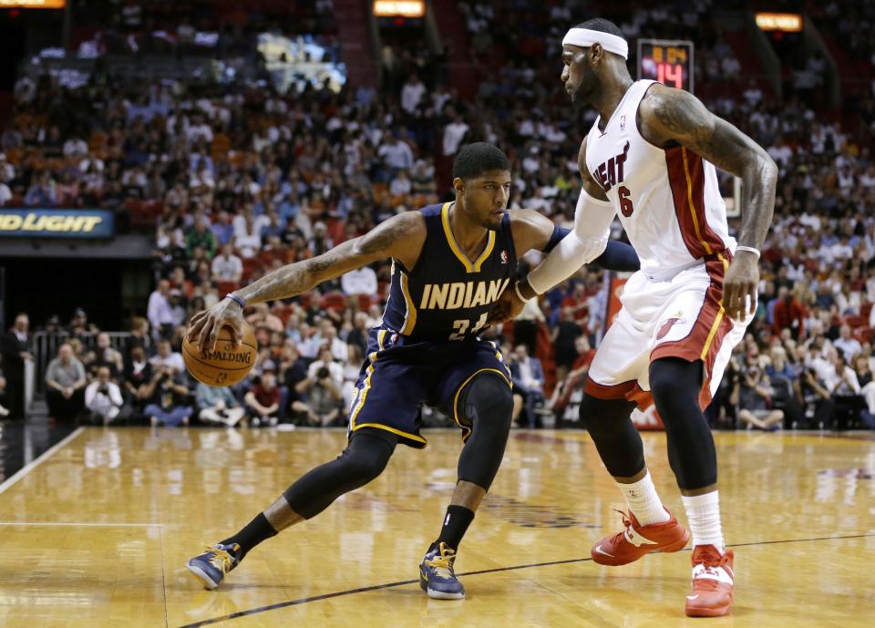 Indiana Pacers' Paul George (24) drives to the basket as Miami Heat's LeBron James (6) defends during the first half of an NBA basketball game, Friday, April 11, 2014, in Miami. (AP Photo/Lynne Sladky)