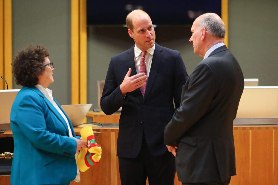 Prince William (C), Prince of Wales, speaks with Senedd members Elin Jones (L) and David Rees during a visit to the Chamber of the Senedd in Cardiff