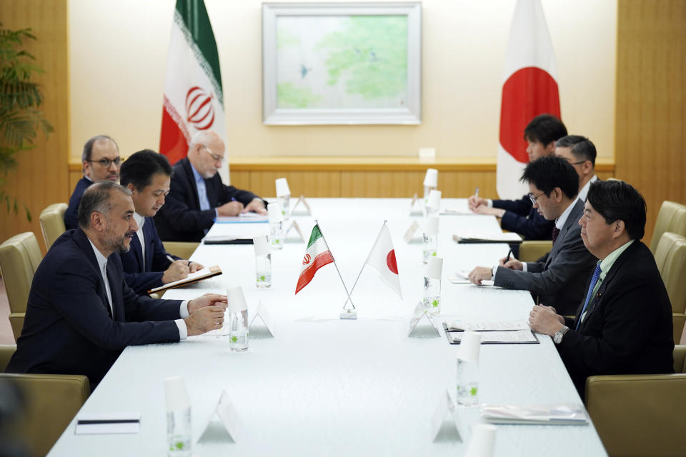 Japanese Foreign Minister Yoshimasa Hayashi, right, and Iranian counterpart Hossein Amir-Abdollahian, left, speak during their meeting Monday, Aug. 7, 2023, in Tokyo. (AP Photo/Eugene Hoshiko)