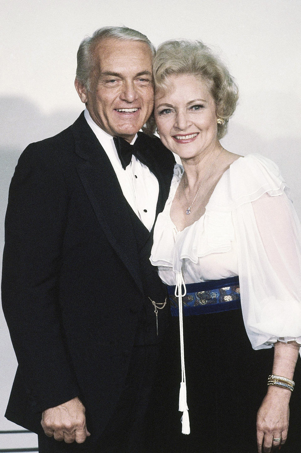 FILE - Actress Betty White stands with Ted Knight at the Emmy Awards in Los Angeles on Sept. 13, 1981. Betty White, whose saucy, up-for-anything charm made her a television mainstay for more than 60 years, has died. She was 99. (AP Photo/Randy Rasmussen, File)