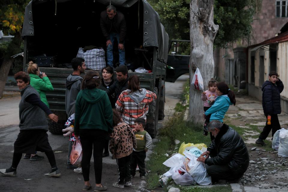 Refugees load a truck in Goris, Armenia, Sept. 26, 2023, before leaving to the capital Yerevan. A continuous stream of vehicles crept along the only road out of the Nagorno-Karabakh region toward Armenia, carrying tens of thousands of refugees. / Credit: ALAIN JOCARD/AFP/Getty