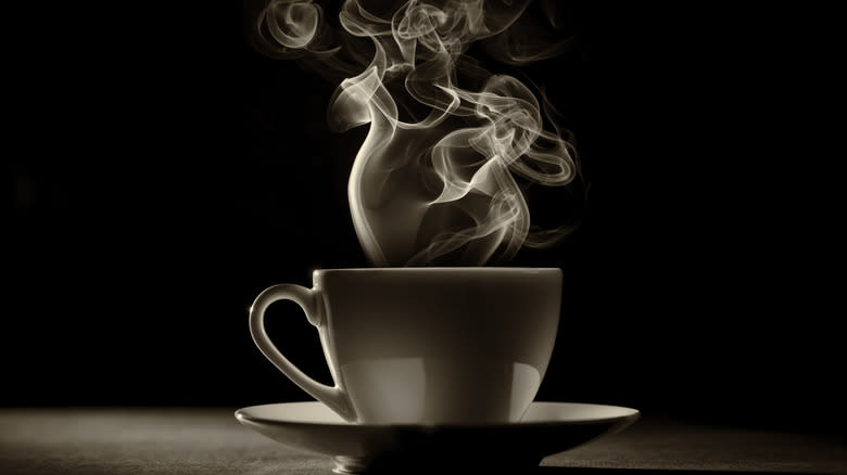 steaming coffee dark background