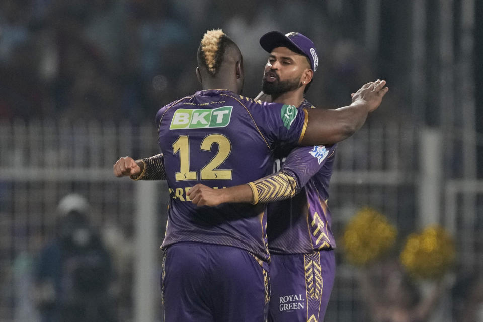 Kolkata Knight Riders' Andre Russell, left, is congratulated by captain Shreyas Iyer for taking the wicket of Royal Challengers Bengaluru's Will Jacks during the Indian Premier League cricket match between Kolkata Knight Riders and Royal Challengers Bengaluru in Kolkata, India, Sunday, April 21, 2024. (AP Photo/Bikas Das)