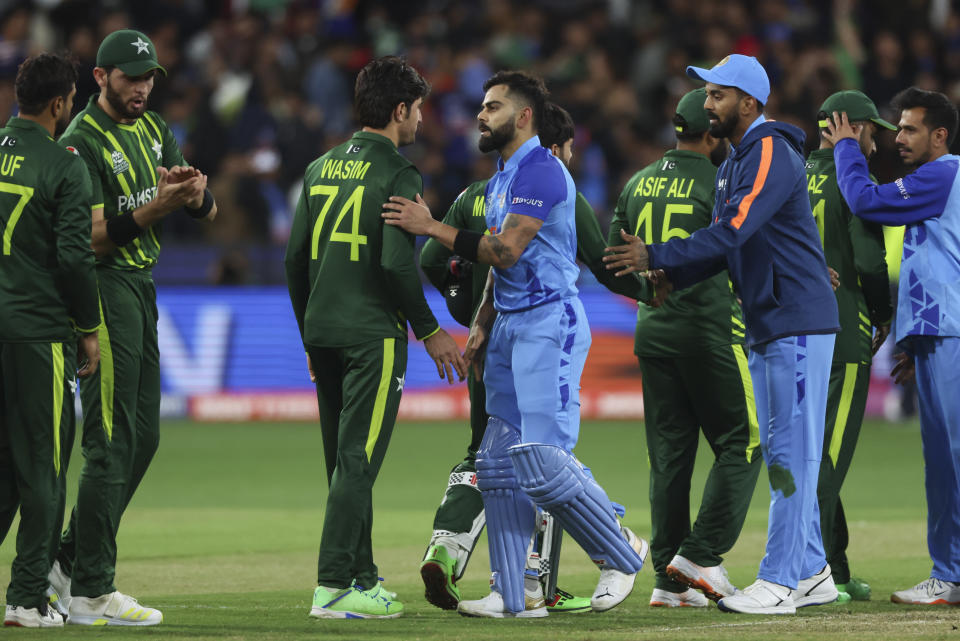 India's Virat Kohli shakes hands with Pakistan's Mohammad Wasim following the T20 World Cup cricket match between India and Pakistan in Melbourne, Australia, Sunday, Oct. 23, 2022. (AP Photo/Asanka Brendon Ratnayake)