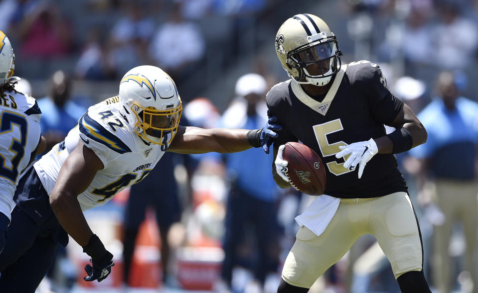 New Orleans Saints quarterback Teddy Bridgewater (5) is pressured by Los Angeles Chargers linebacker Uchenna Nwosu (42) during the first half of a preseason NFL football game Sunday, Aug. 18, 2019, in Carson, Calif. (AP Photo/Kelvin Kuo)
