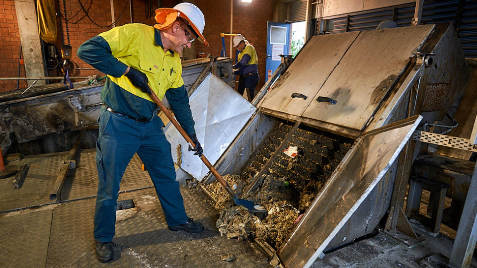 Urban Utilities staff work to remove a one-tonne rag ball blocking the sewerage at the Bundamba Plant. 