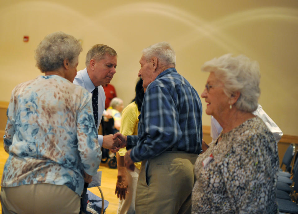 Sen. Lindsey Graham, second from left, greets supporters after speaking during a campaign stop at American Legion Post 20 on Wednesday, April 23, 2014, in Greenwood, S.C. (AP Photo/Rainier Ehrhardt)