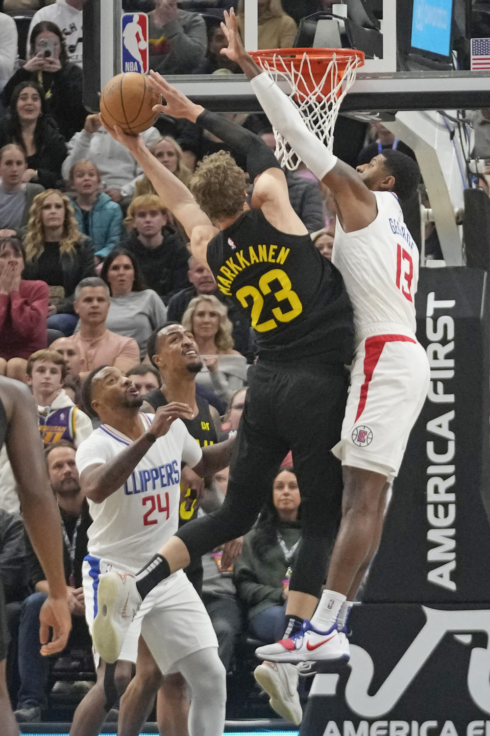 Utah Jazz forward Lauri Markkanen (23) goes to the basket as Los Angeles Clippers forward Paul George (13) defends during the second half of an NBA basketball game Friday, Oct. 27, 2023, in Salt Lake City. (AP Photo/Rick Bowmer)