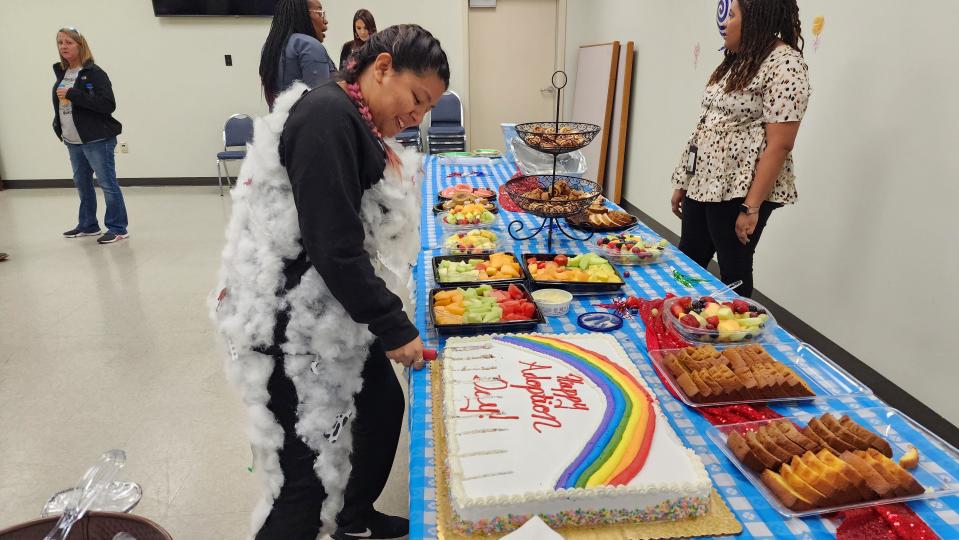 The cake is cut by the tornado from "The Wizard of Oz" Nov. 17 during the National Adoption Day event at the Randall County Courthouse in Canyon.