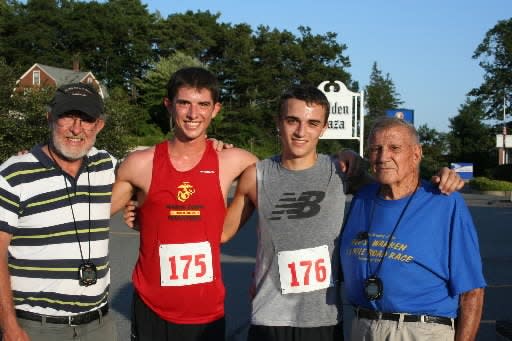 Former Wachusett Regional coach Brian Wallace, left, poses with former Wachusett standouts Jeremy and Colin Bennie, and former Wachusett cross-country and track coach Fred Warren at the 2012 Fred Warren Road Race.