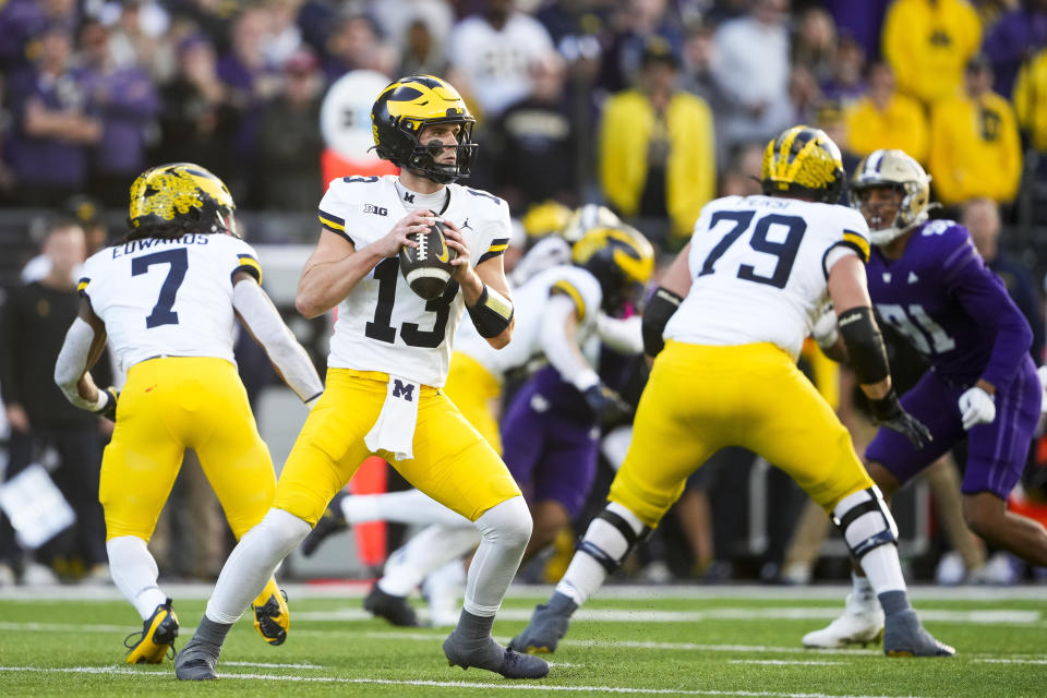 Michigan quarterback Jack Tuttle (13) looks to pass against Washington during the first half of an NCAA college football game Saturday, Oct. 5, 2024, in Seattle. (AP Photo/Lindsey Wasson)