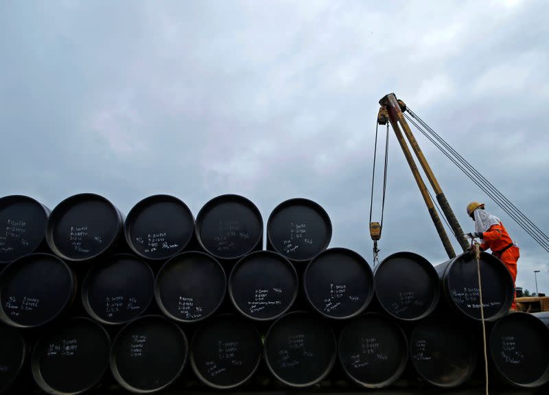 A worker prepares to transport oil pipelines to be laid for Pengerang Gas Pipeline Project in Johor