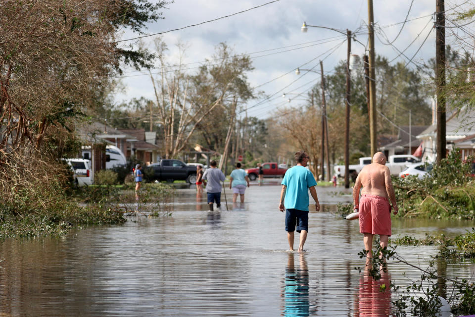 Residents walk down a flooded residential street in the aftermath of Hurricane Ida on Aug. 30, 2021 in Norco, La. (Scott Olson / Getty Images file)