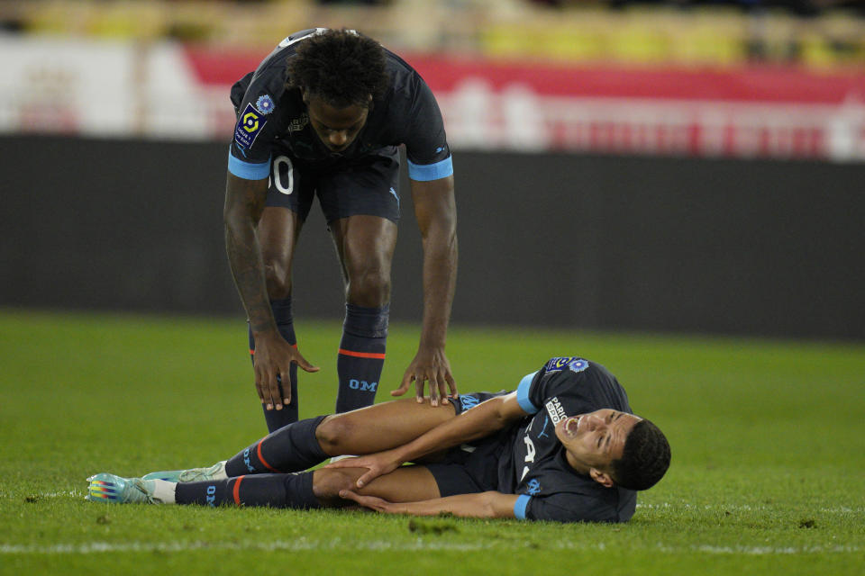 Marseille's Amine Harit lies on the pitch in pain during the French League One soccer match between Monaco and Marseille at the Stade Louis II in Monaco, Sunday, Nov. 13, 2022. (AP Photo/Daniel Cole)