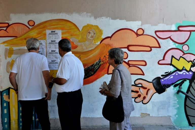 People check voting information outside a polling station during the Greek referendum in Thessaloniki, on July 5, 2015