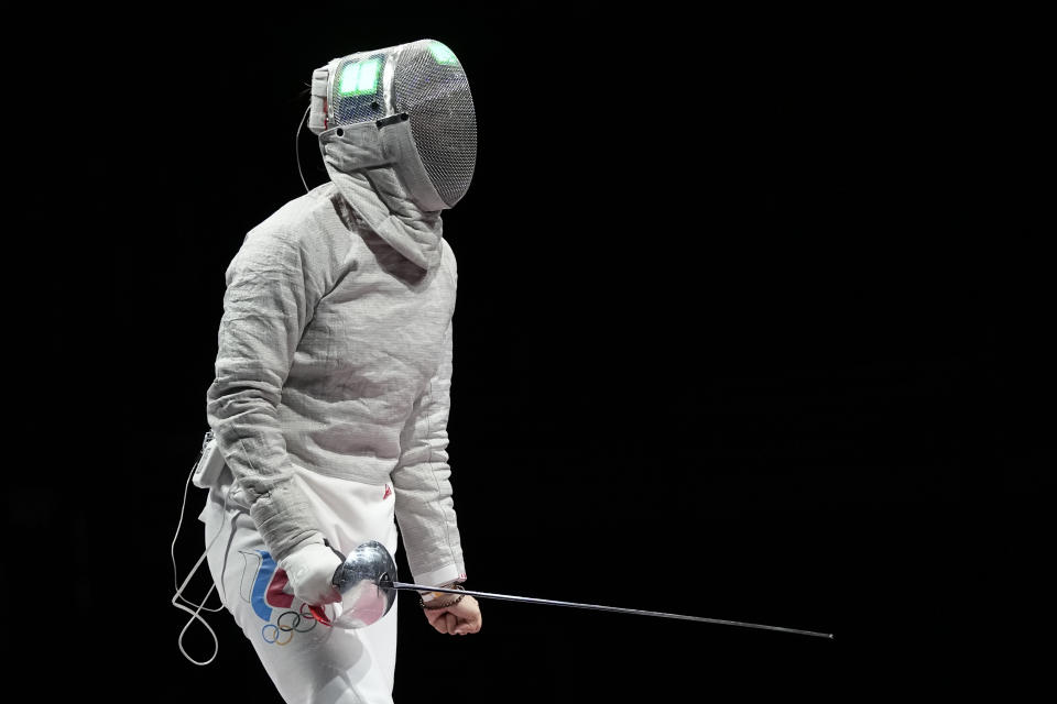 Sofia Pozdniakova of the Russian Olympic Committee celebrates winning a point as competes Cecilia Berder of France in the women's Sabre team final competition at the 2020 Summer Olympics, Saturday, July 31, 2021, in Chiba, Japan. (AP Photo/Hassan Ammar)