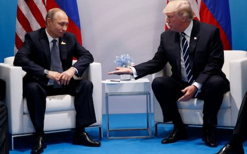 Trump Putin handshake - Credit: AP