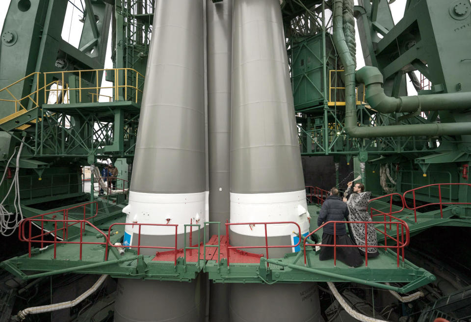 Russian Orthodox priests bless the Soyuz 2.1a rocket before launch in a long-standing tradition at the Baikonur Cosmodrome. / Credit: NASA/Bill Ingalls