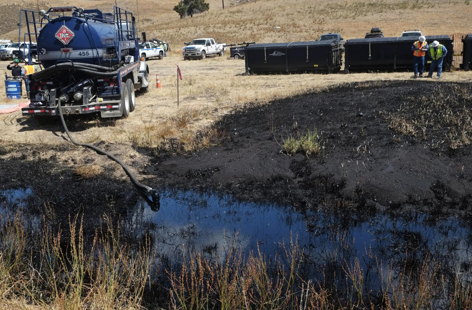 FILE - In this May 20, 2015, file photo, clean-up workers monitor the site of an underground oil pipeline break near Refugio State Beach, north of Goleta, Calif. The 24-inch pipeline, owned by Plains All American Pipeline, spewed oil down a storm drain and into the Pacific for several hours before it was shut off. A California jury has found the pipeline company guilty of nine criminal charges for causing a 2015 oil spill that was the state's worst coastal spill in 25 years. The jury reached its verdict against Plains All American Pipeline of Houston on Friday, Sept. 7, 2018, following a four-month trial. (AP Photo/Michael A. Mariant, File)