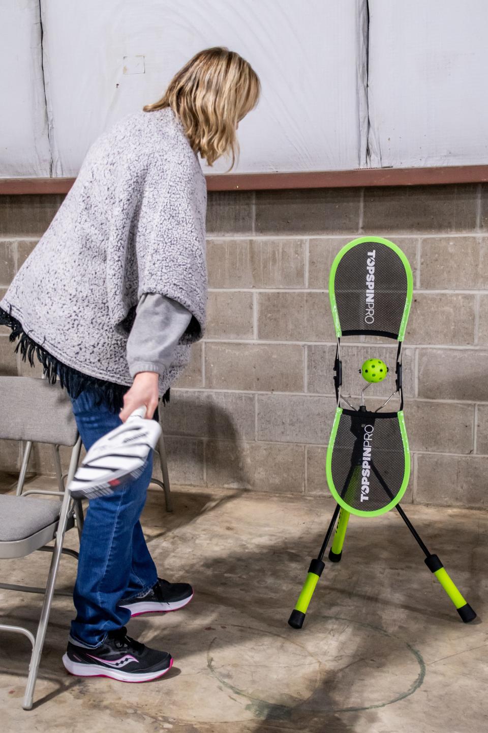 Cathie Akins of Coshocton tries out the TopSpin Pro machine at the newly opened Hilltop Pickleball Facility in Cambridge.