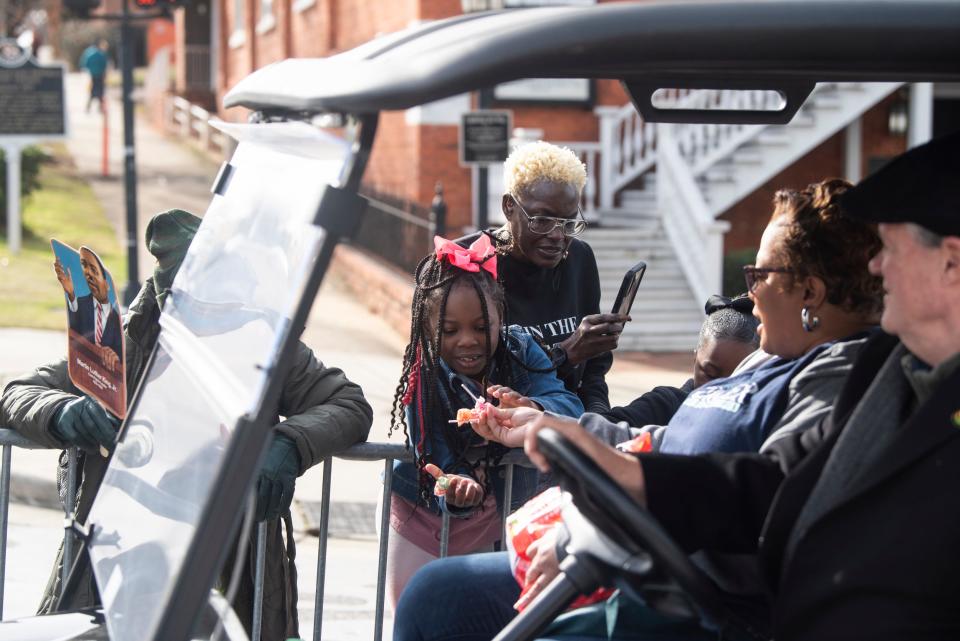 Kids get candy during Martin Luther King Jr. Day parade on Dexter Ave. in Montgomery, Ala., on Monday, Jan. 15, 2024.