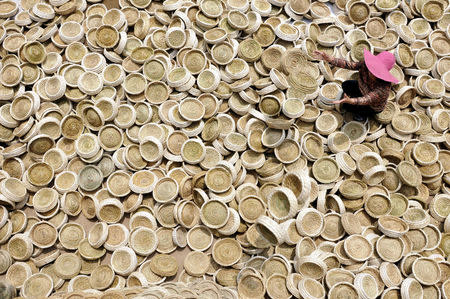 A worker puts aside handicrafts of bird nests as she sits among them in Linyi, Shandong Province, China, May 30, 2016. REUTERS/Stringer ATTENTION EDITORS - THIS IMAGE WAS PROVIDED BY A THIRD PARTY. EDITORIAL USE ONLY. CHINA OUT. NO COMMERCIAL OR EDITORIAL SALES IN CHINA. TPX IMAGES OF THE DAY