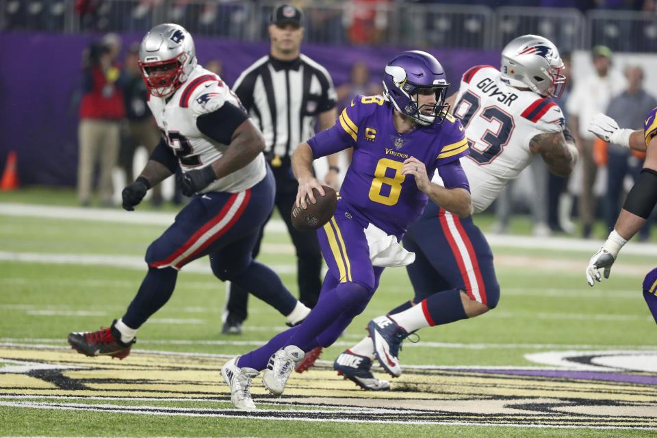 Minnesota Vikings quarterback Kirk Cousins (8) scrambles up field during the first half of an NFL football game against the New England Patriots, Thursday, Nov. 24, 2022, in Minneapolis. (AP Photo/Bruce Kluckhohn)