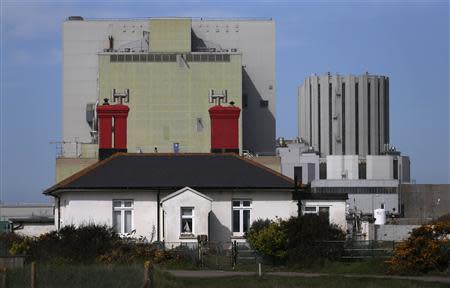A house is seen in front of Dungeness nuclear power station in Kent, southern England April 30, 2013. REUTERS/Suzanne Plunkett