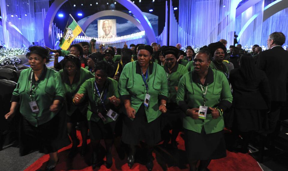 Guests sing during the funeral ceremony of former South African President Nelson Mandela in Qunu