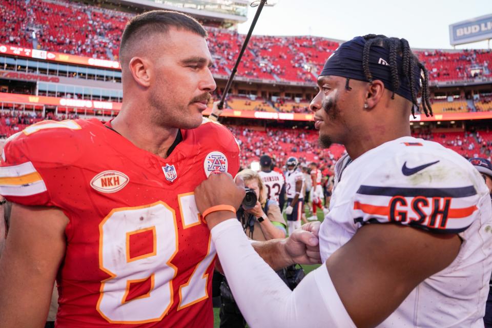 Kansas City Chiefs tight end Travis Kelce (87) talks with Chicago Bears quarterback Justin Fields (1) on field after the game at GEHA Field at Arrowhead Stadium.