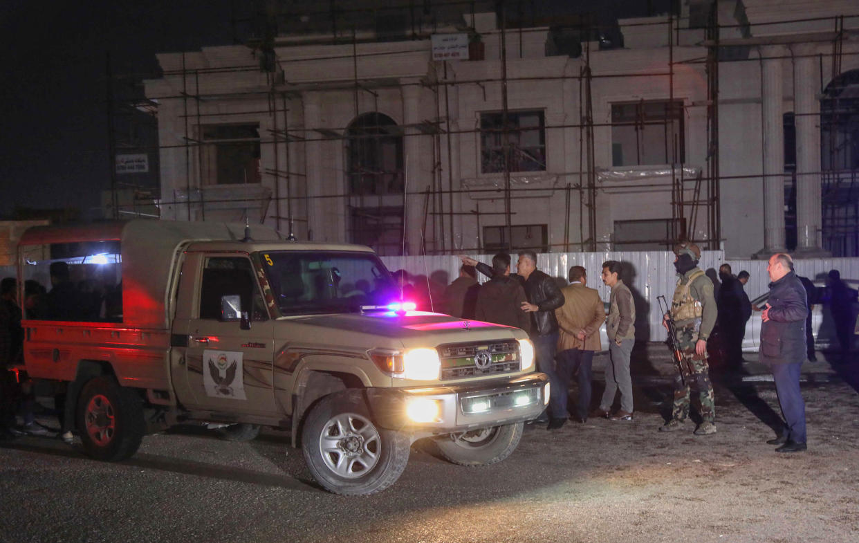 Security forces gather following a rocket attack in Arbil, the capital of the northern Iraqi Kurdish autonomous region, on February 15, 2021. - A volley of rockets targeted the Kurdish regional capital in northern Iraq late today, authorities said, as security sources confirmed that at least one hit a military complex hosting US-led coalition troops. (Photo by SAFIN HAMED / AFP) (Photo by SAFIN HAMED/AFP via Getty Images)