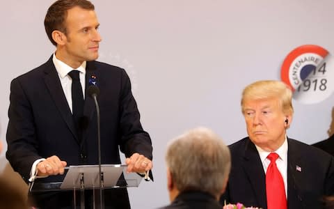 French President Emmanuel Macron delivers a speech while President Donald Trump looks on before a lunch at the Elysee Palace, in Paris, - Credit: AFP POOL