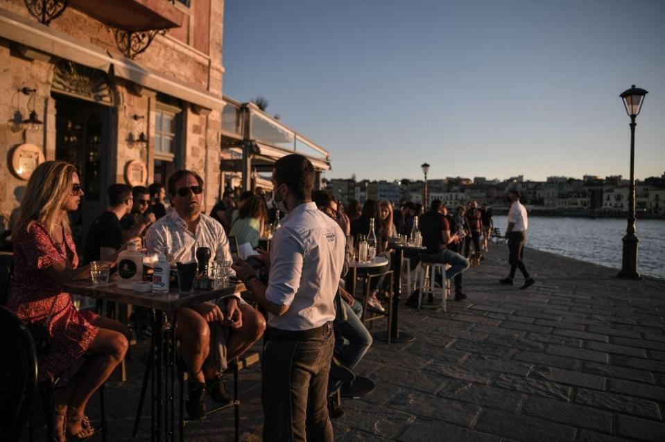 People at an outdoor bar in Greece.