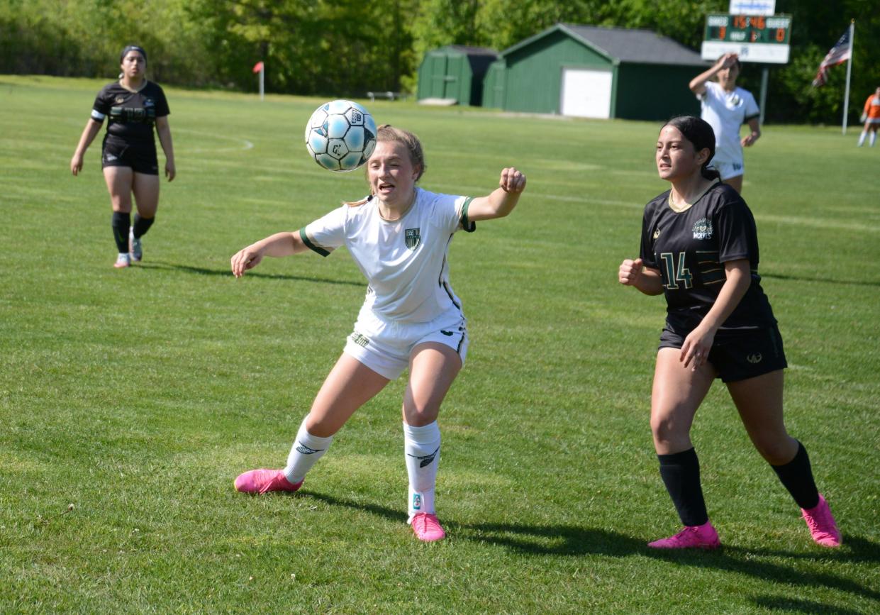 Nora Kinsey of St. Mary Catholic Central beats Detroit Cristo Rey's Lupita Bermudez to the ball during a Division 4 District game Thursday.